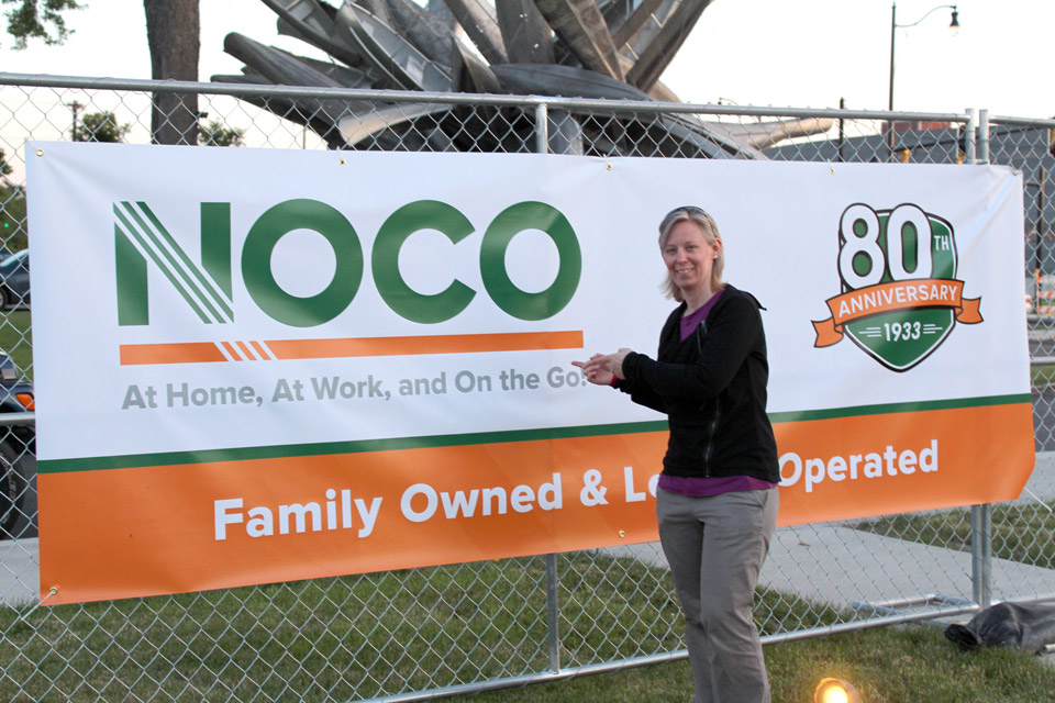 Kristin next the the NOCO banner at the POParazzi event